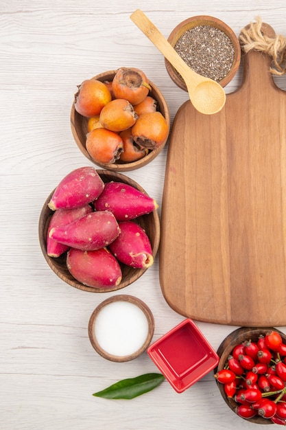 Free Photo top view different fresh fruits inside plates on white background tropical ripe color diet exotic healthy life