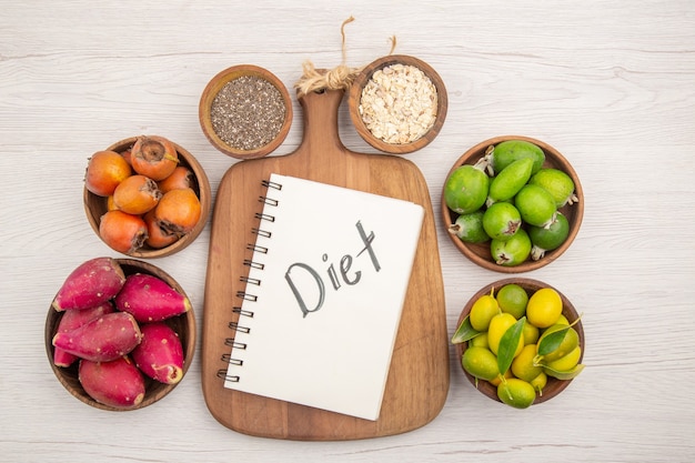 Free Photo top view different fresh fruits inside plates on white background tropical ripe healthy life color diet exotic