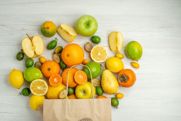 Top view different fresh fruits on a white background