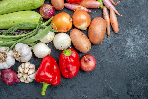 Free photo top view different fresh vegetables on dark table vegetable fresh color ripe