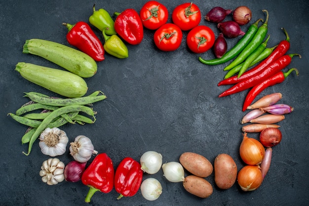 Top view different fresh vegetables on dark table vegetable fresh color salad ripe