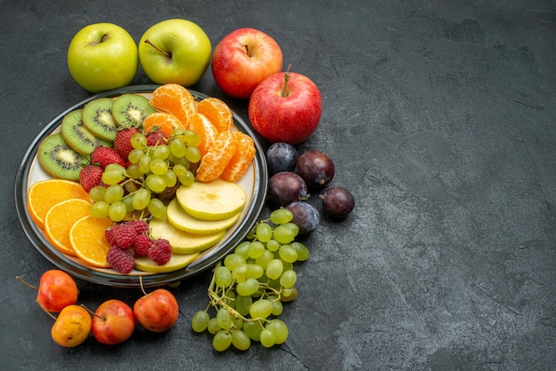 Top view different fruits composition fresh and ripe on dark background mellow fruits health ripe