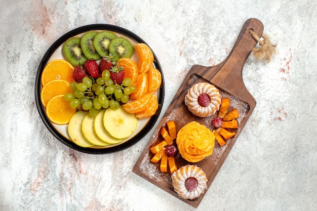 Free photo top view different fruits composition fresh and ripe on white background ripe fruits mellow color health