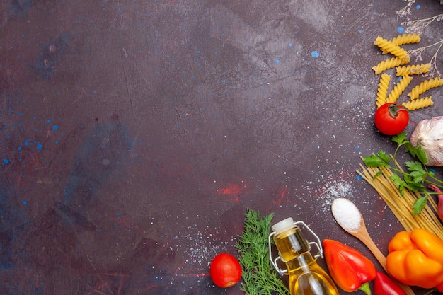 Top view different ingredients raw pasta and fresh vegetables on dark background product food health salad diet