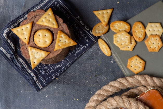 Top view different salted crackers lined all over the grey background cracker crisp snack photo