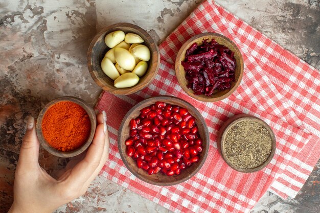 Top view different seasonings garlics pomegranates and beet on a light background