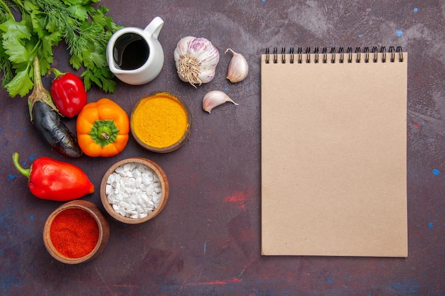 Top view different seasonings with fresh vegetables on dark background salad vegetable product food meal