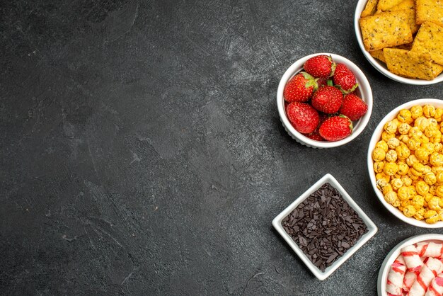 Top view different snacks fruits and crackers