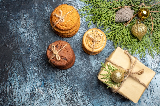 Top view different sweet biscuits with present on light background