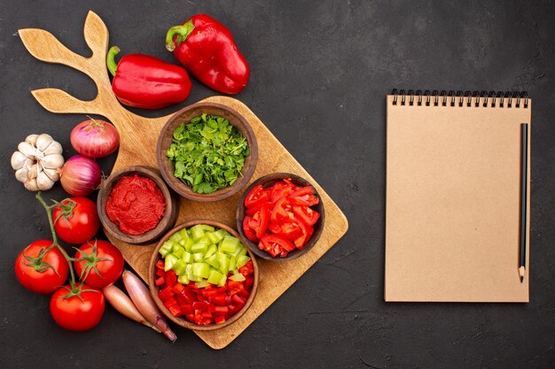 Top view different vegetables with greens on a grey background salad meal health ripe spicy