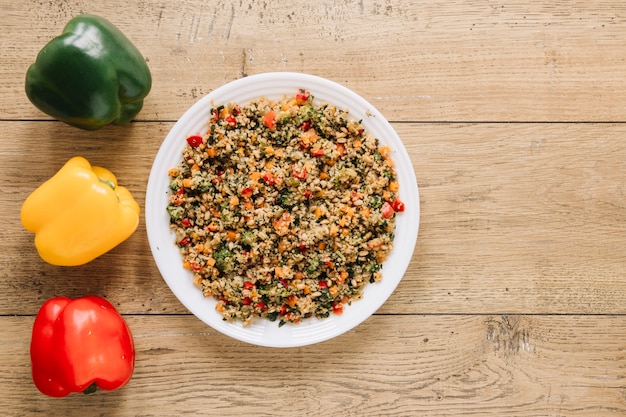 Top view of dishes with colorful bell peppers and copy space