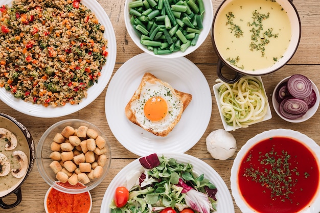 Top view of dishes with fried egg and tomato soup