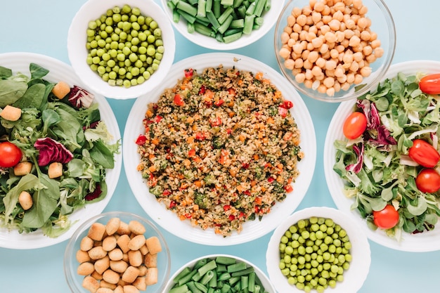 Top view of dishes with salads and chickpeas