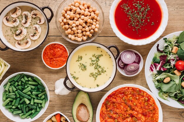 Top view of dishes with soups and green beans