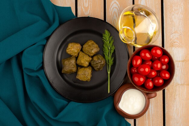 top view dolma green along with olive oil and yogurt on the wooden floor