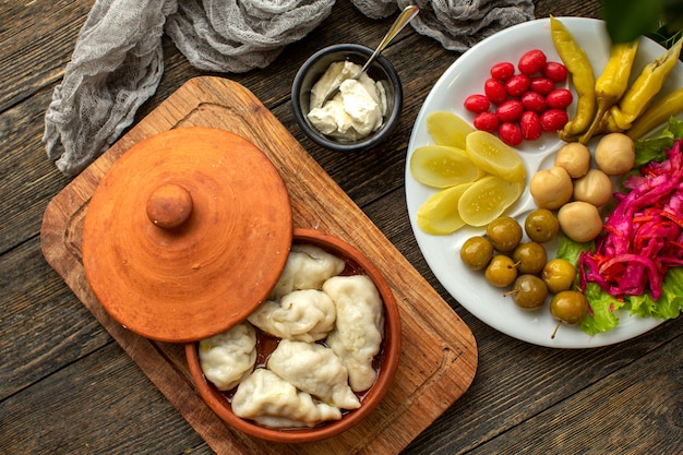 A top view dough meal with minced meat inside along with fresh vegetables