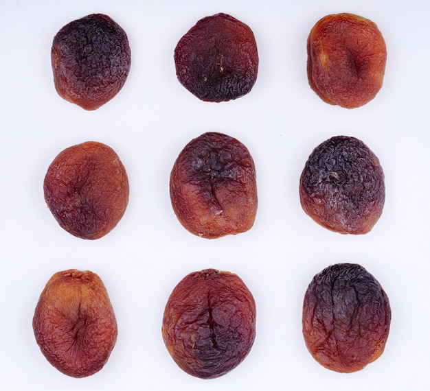 Free photo top view of dried apricots isolated on white background