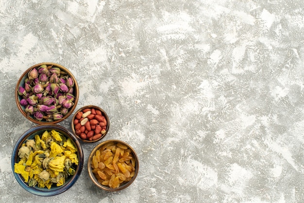 Free Photo top view dried flowers with nuts and raisins on white background nut raisin flower plant