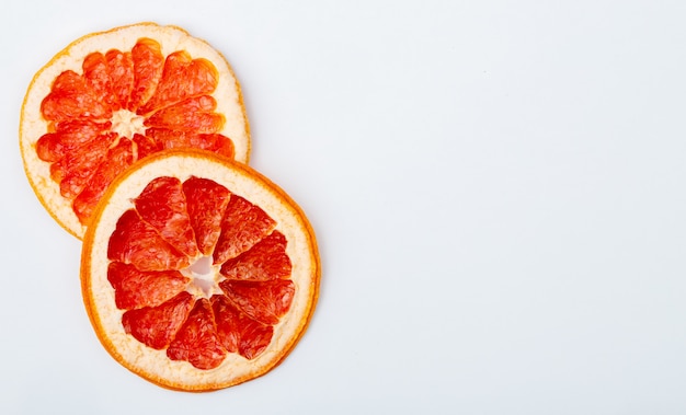 Top view of dried grapefruit slices isolated on white background with copy space