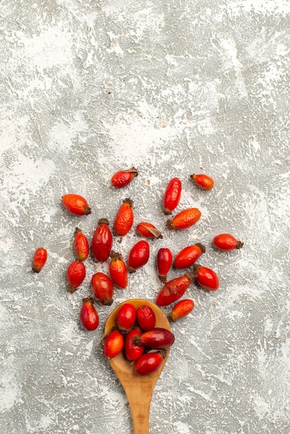 Free photo top view dried red fruits on white surface fruit dry color