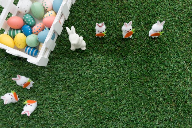 Top view of easter composition with fence, rabbits and eggs