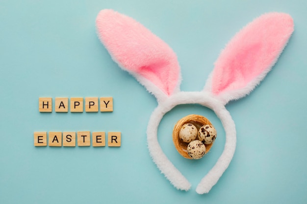 Top view of easter eggs with greeting and bunny ears