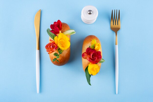 Top view eco hot dogs with flowers