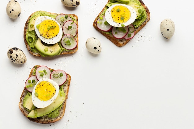 Free Photo top view of egg and avocado sandwiches with copy space