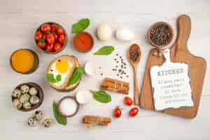 Free photo top view egg toasts with tomatoes and seasonings on white background photo morning breakfast lunch salad color food