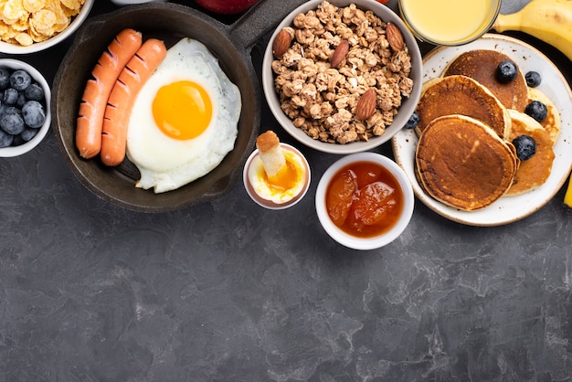 Top view of egg with sausages and cereal for breakfast