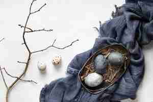 Free photo top view of eggs for easter with fabric and twig