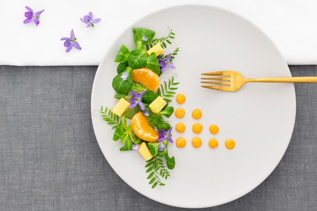 Top view elegant plate with golden fork