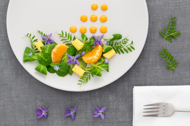 Top view elegant plate with salad and fork