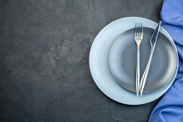 Top view elegant plates with fork and knife on dark background grace hunger diner silverware colourful