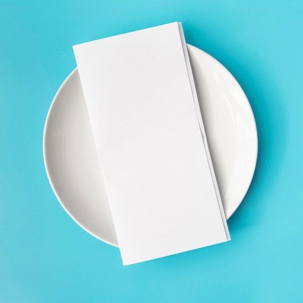 Top view of empty menu paper on white plate