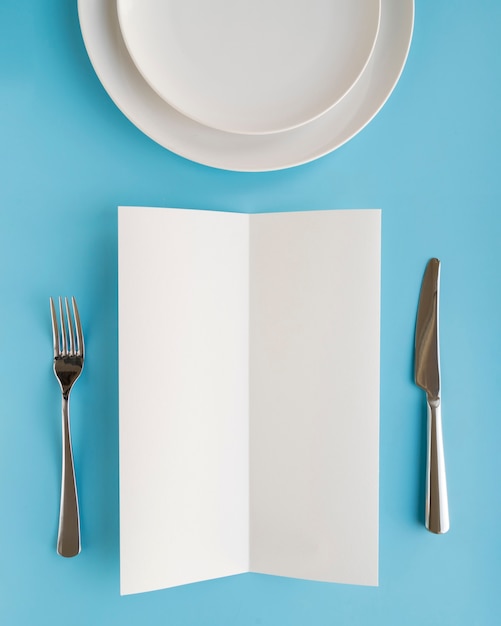 Free Photo top view of empty menu paper with plates and cutlery