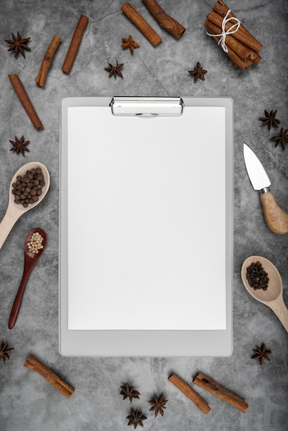 Free Photo top view of empty menu with cinnamon sticks and star anise