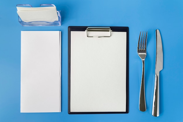 Free Photo top view of empty menu with fork and knife