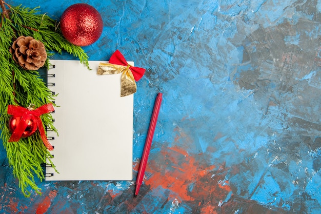 Top view empty open notepad with red pencil and toys