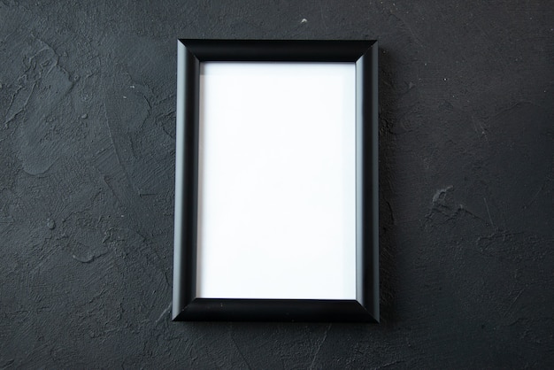 Top view of empty picture frame on a dark wall