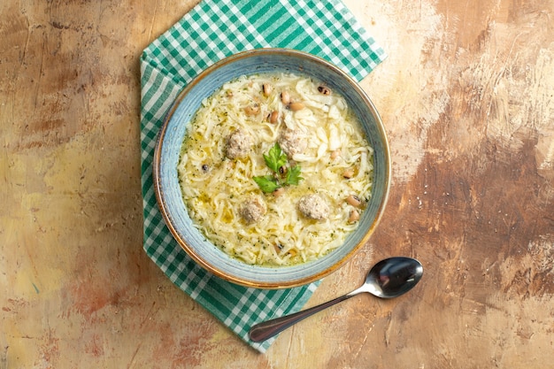 Top view erishte in bowl spoon on beige background