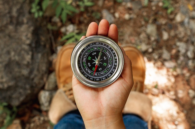 Top view female using compass for directions