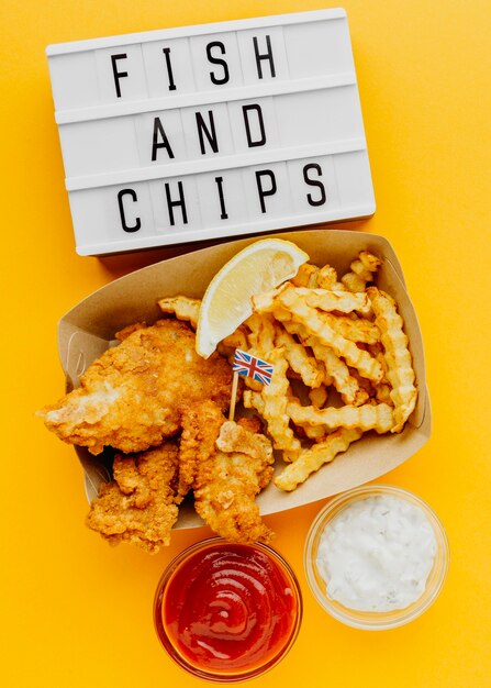 Top view of fish and chips with light box and sauce