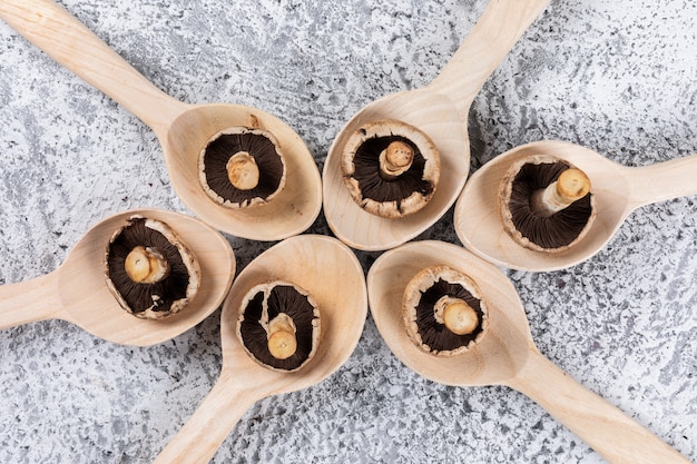 Free photo top view flipped mushrooms in spoons