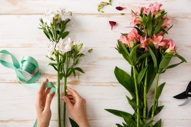 Free Photo top view florist hands making bouquet