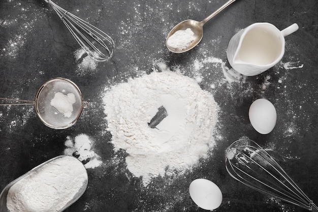 Top view flour with baking tools on the table