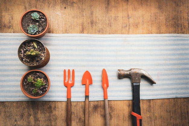 Top view flowerpots with gardening tools