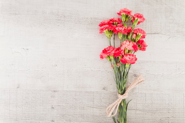 Top view flowers bouquet on wooden background