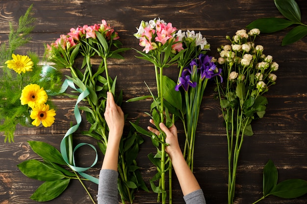 Top view of flowers, florist in process of making bouquet