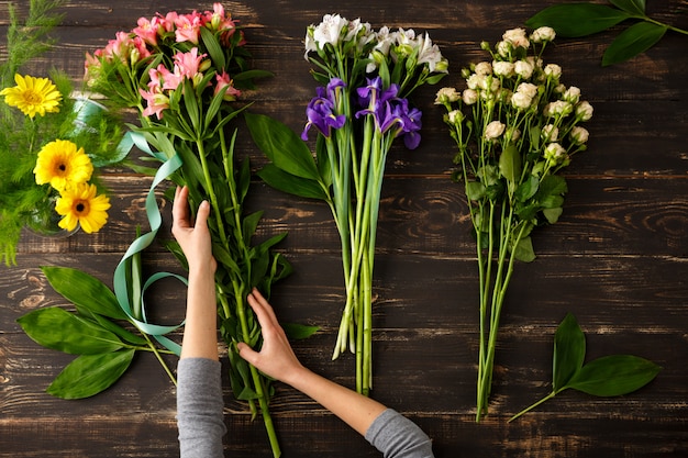 Top view of flowers, process of making bouquet